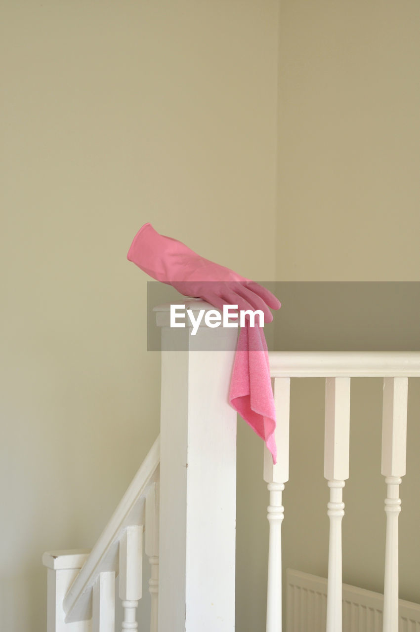 Pink latex glove on stair railing 