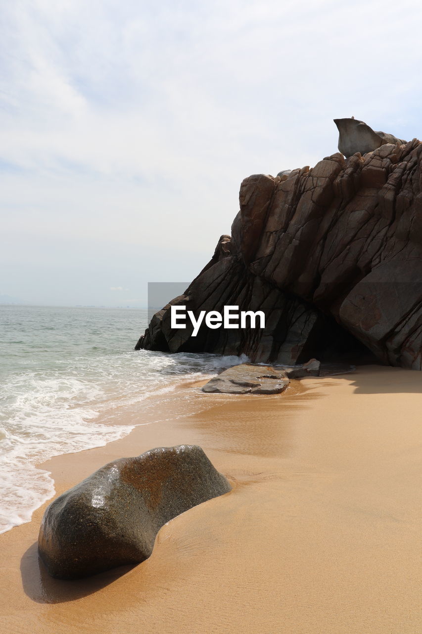 nature, rock, sky, water, temple, day, no people, wood, architecture, outdoors, low angle view, sea, land, motion, cloud, travel destinations, blue, built structure, sand