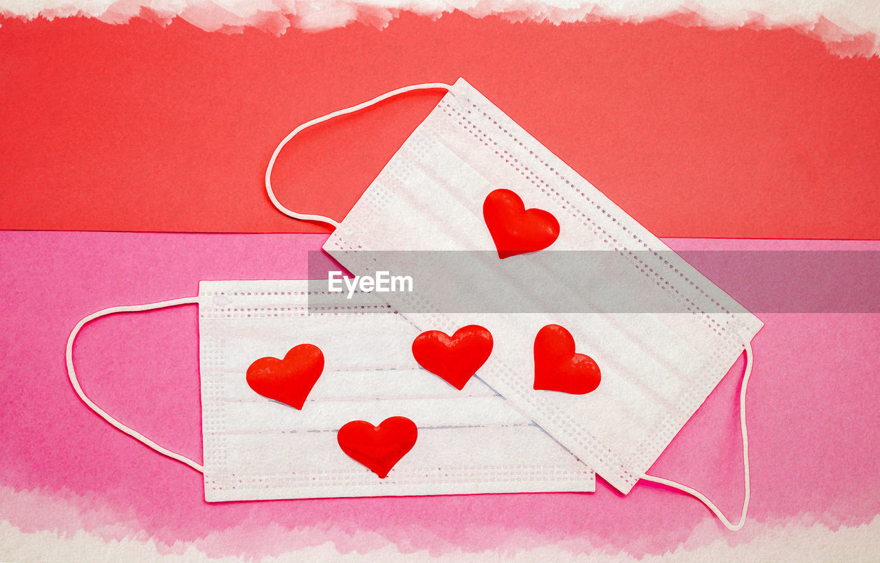 HIGH ANGLE VIEW OF HEART SHAPE MADE ON PINK PAPER