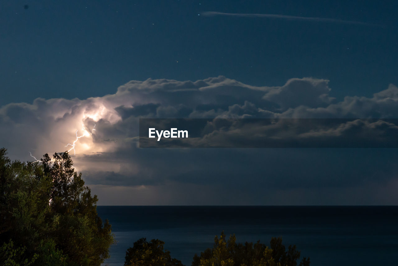 Scenic view of sea against sky at night