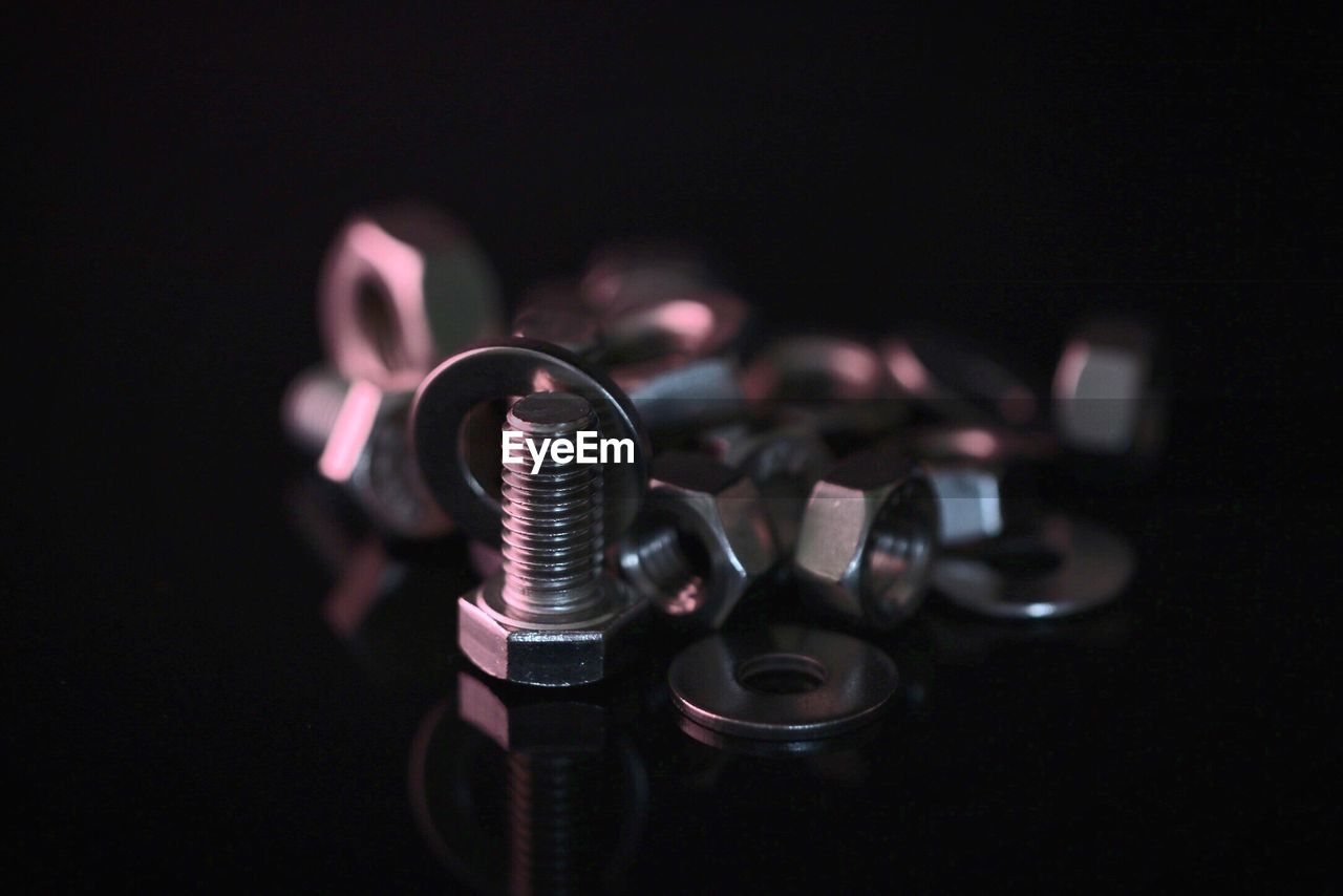 High angle view of nut and bolt against black background