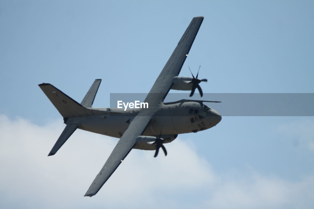 LOW ANGLE VIEW OF AIRPLANE IN SKY