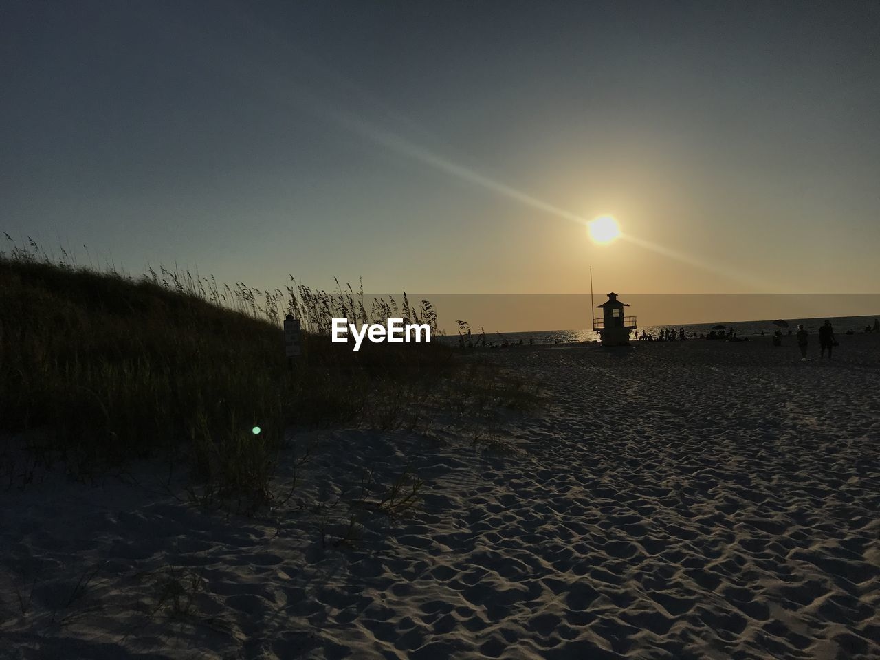 Scenic view of beach against sky during sunset