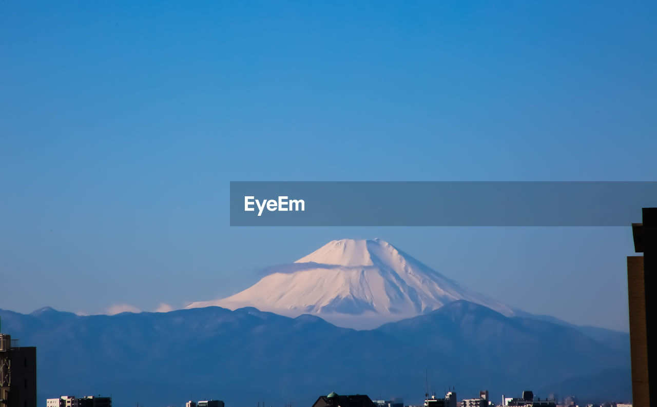 View of snowcapped mountain against blue sky