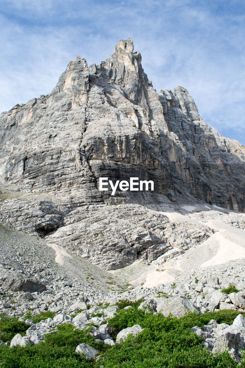 Low angle view of rock formation against sky