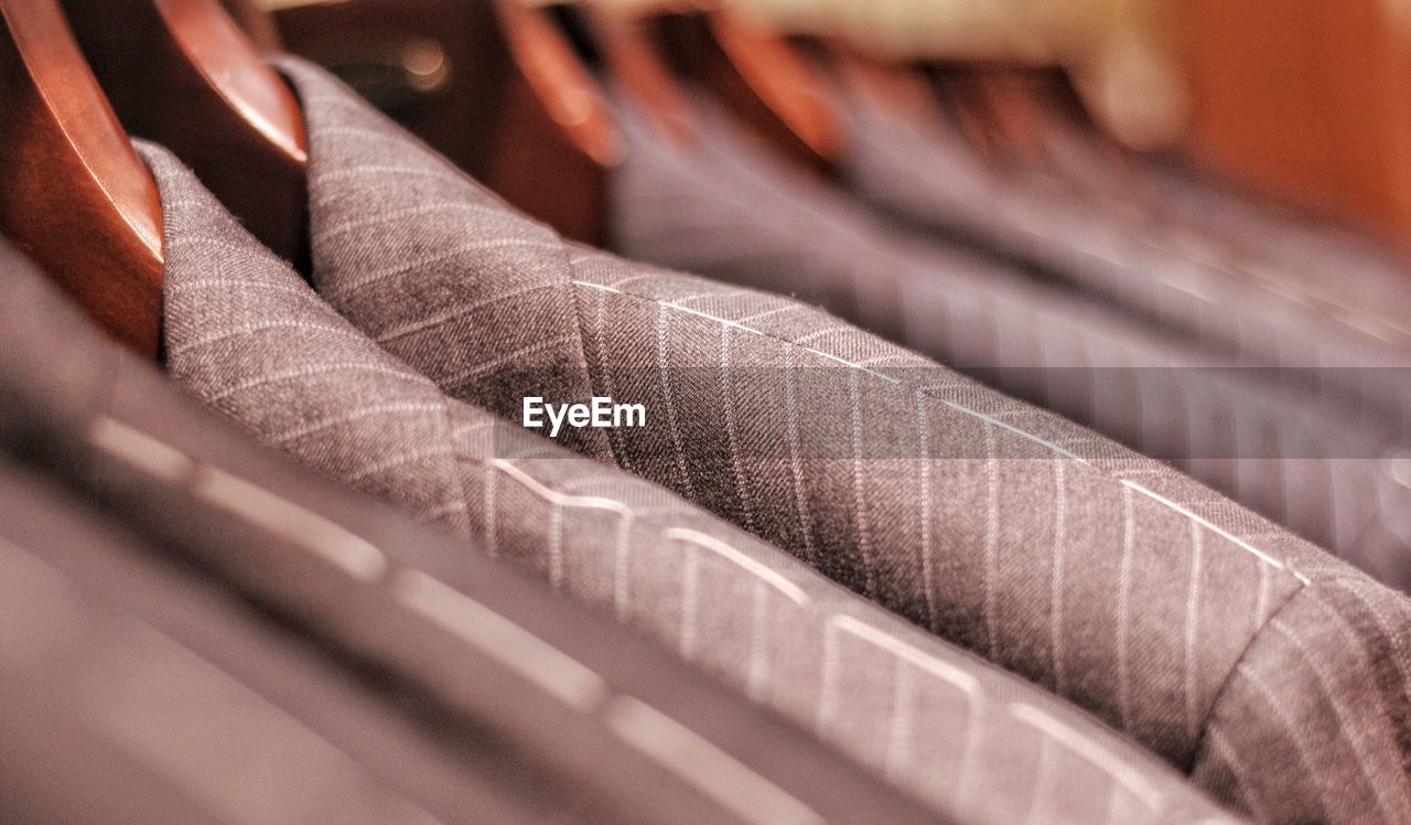 Full frame shot of clothes hanging on rack. business suits