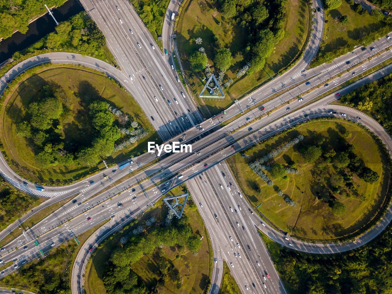 HIGH ANGLE VIEW OF HIGHWAY AND TREES IN CITY