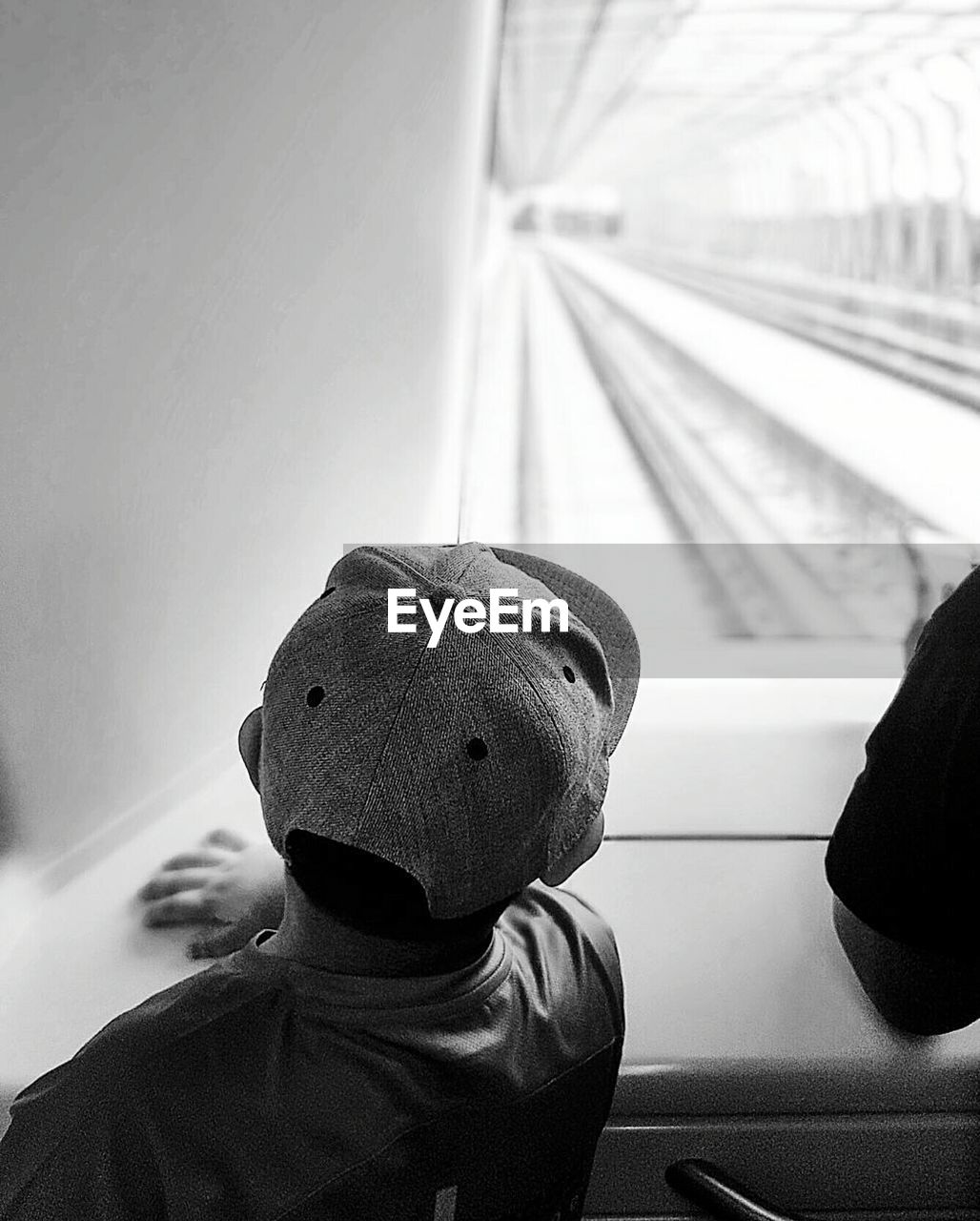 Rear view of boy traveling in train