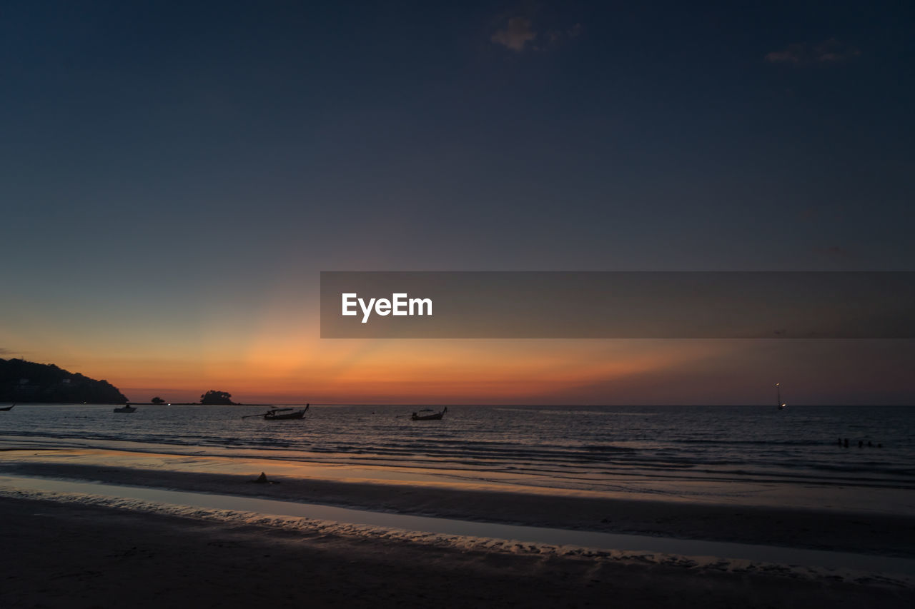 SCENIC VIEW OF BEACH DURING SUNSET