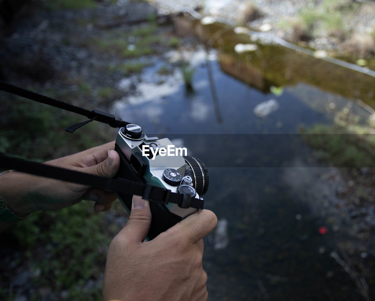 Close-up of cropped hands photographing from camera