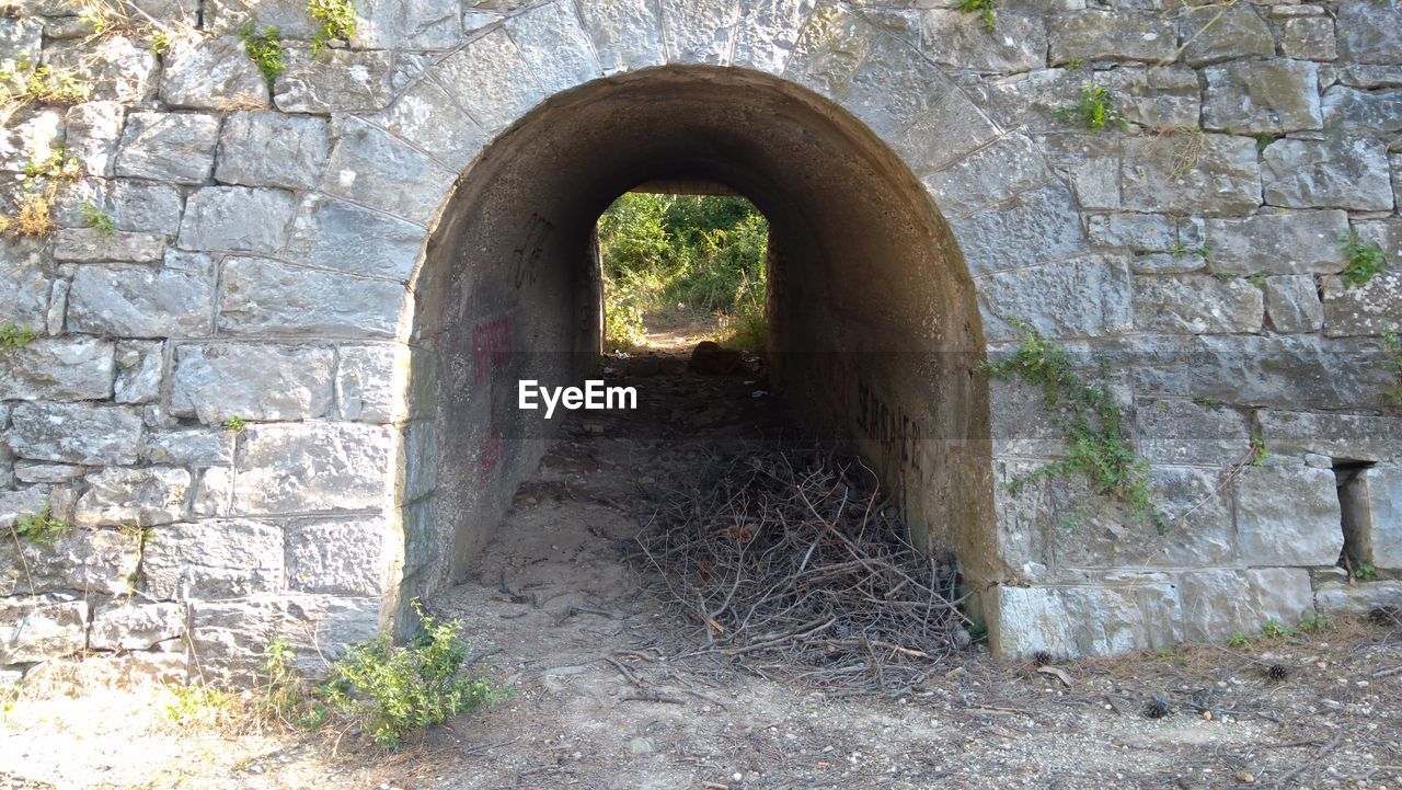 VIEW OF OLD WALL THROUGH HOLE IN BRICK WALLS