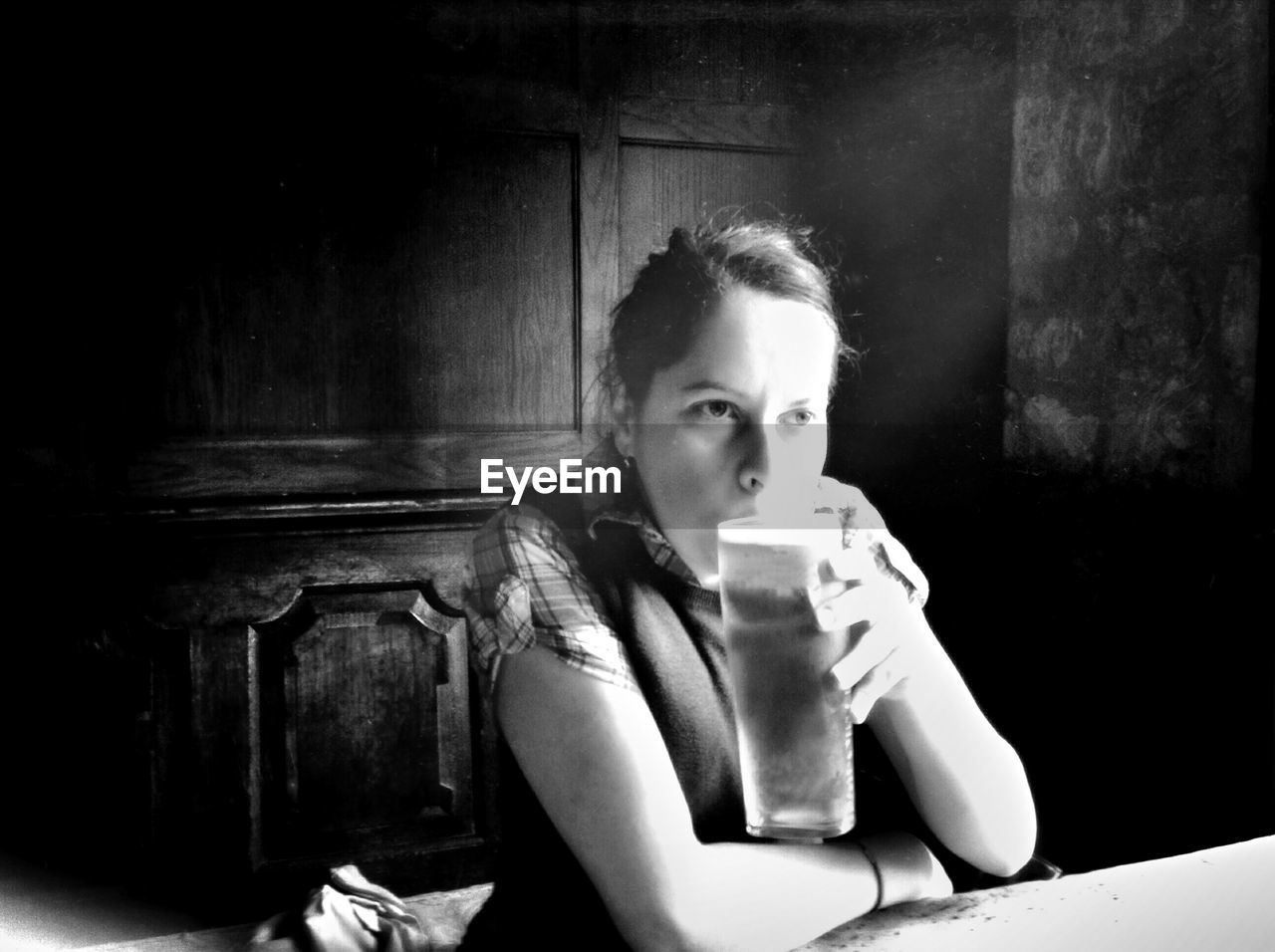 Woman drinking beer at restaurant