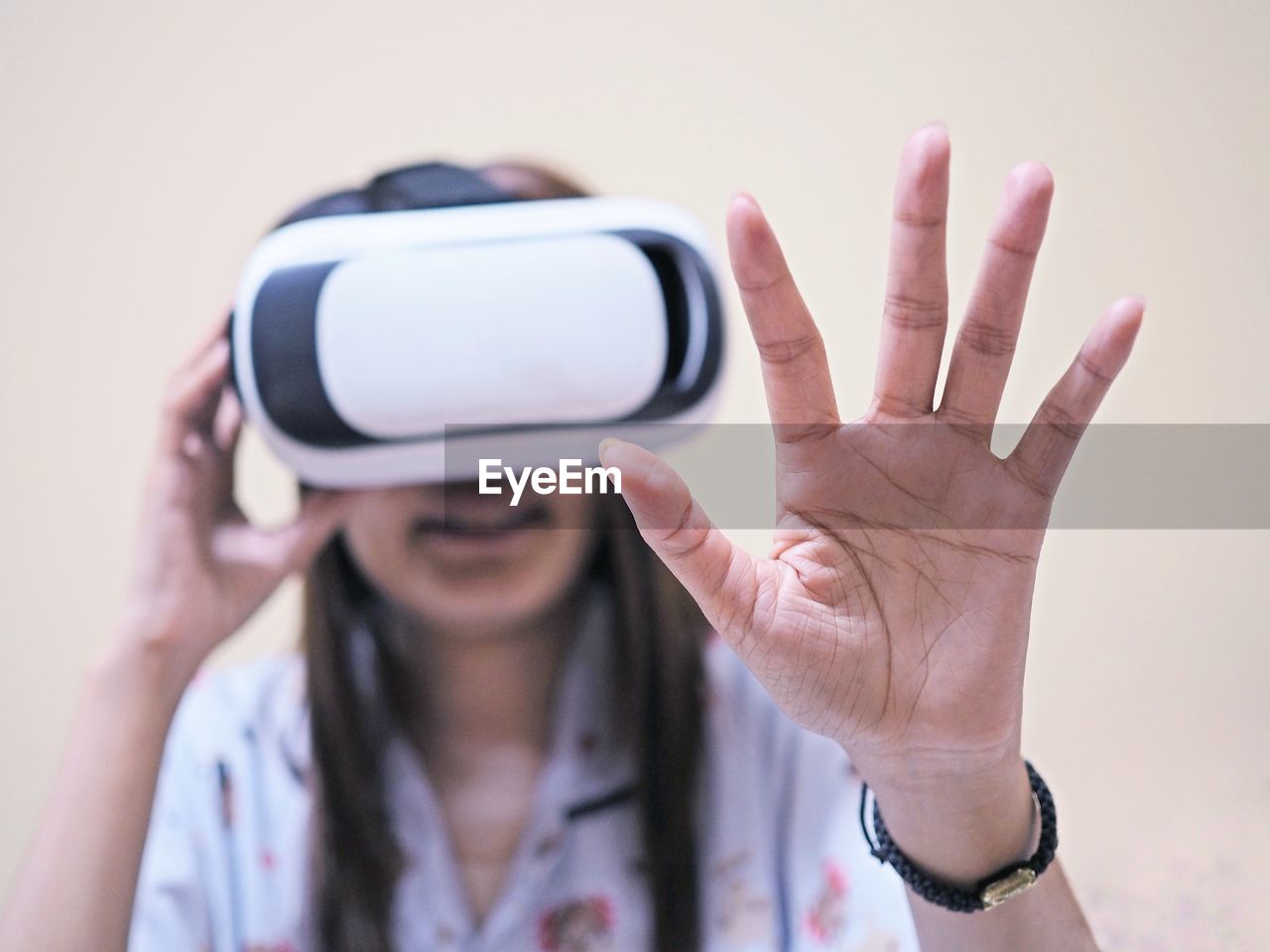 Woman gesturing while using virtual reality simulator