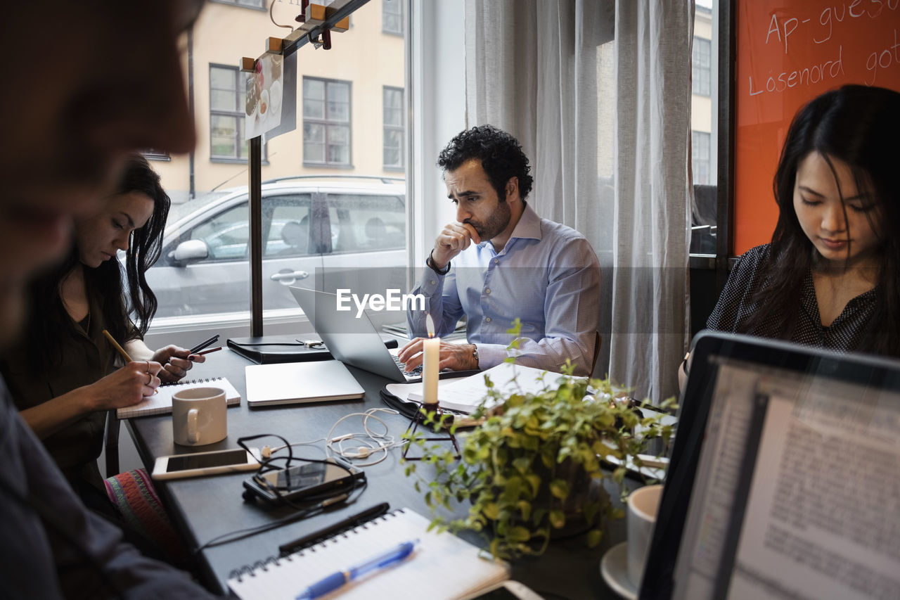Creative business team working at table in modern office