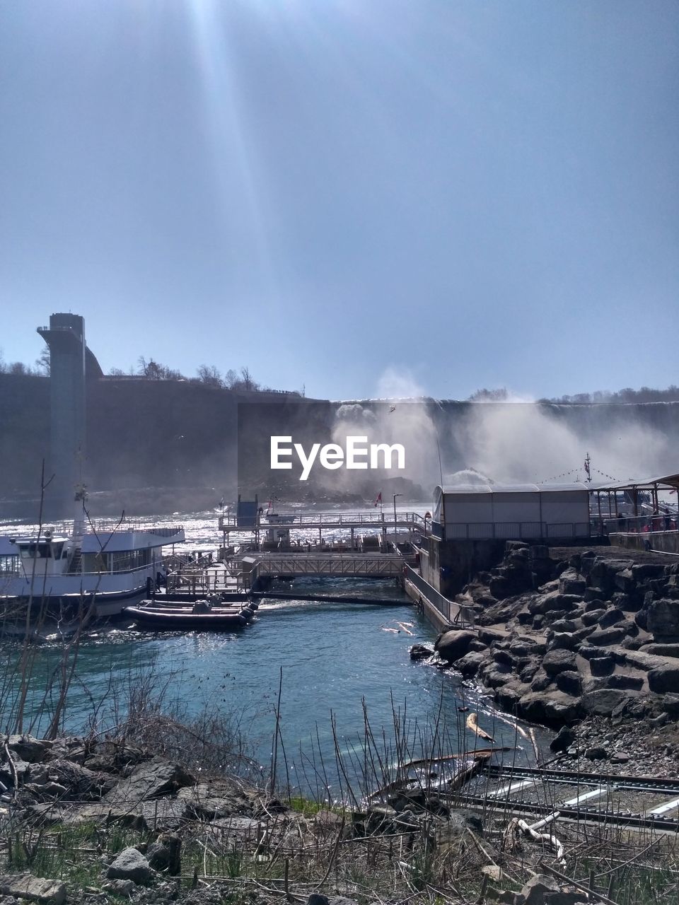 PANORAMIC VIEW OF HARBOR AT FACTORY AGAINST SKY