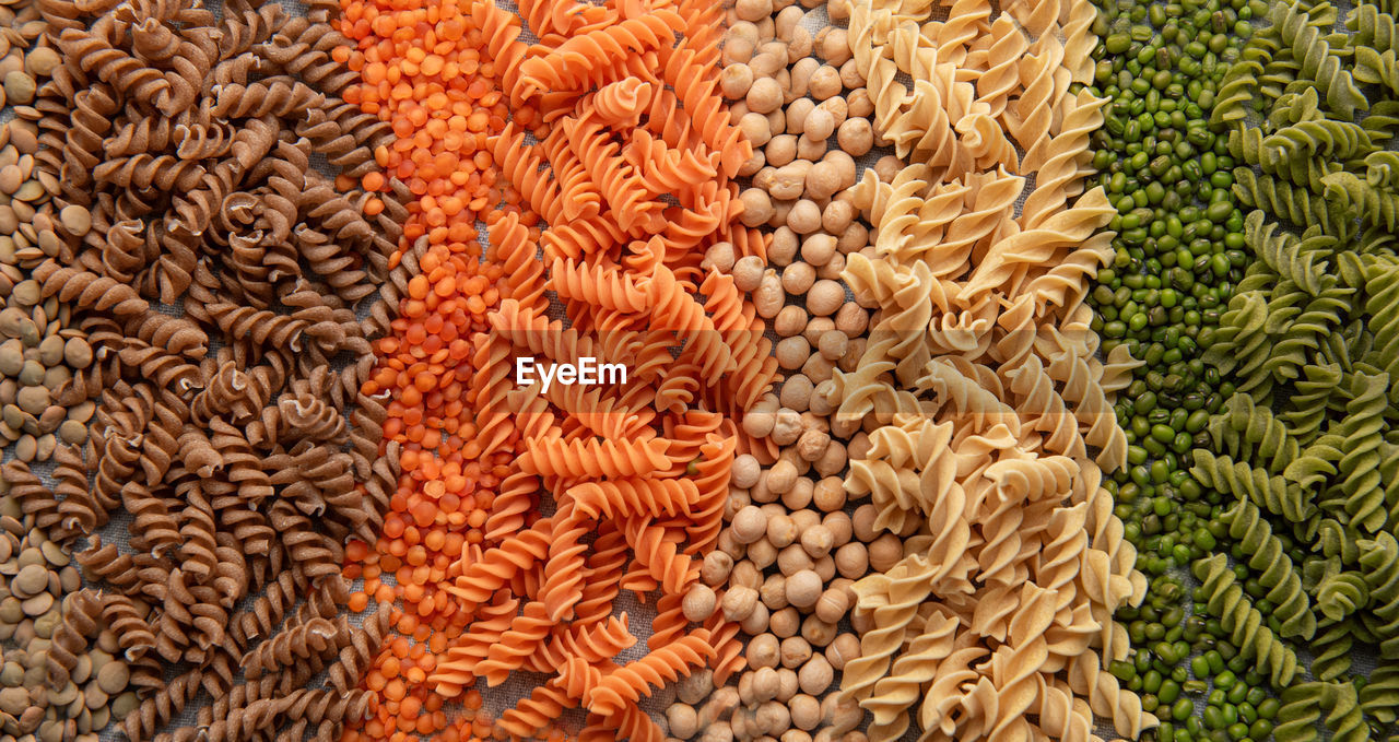 A variety of fusilli pasta made from different types of legumes, green and red lentils, 