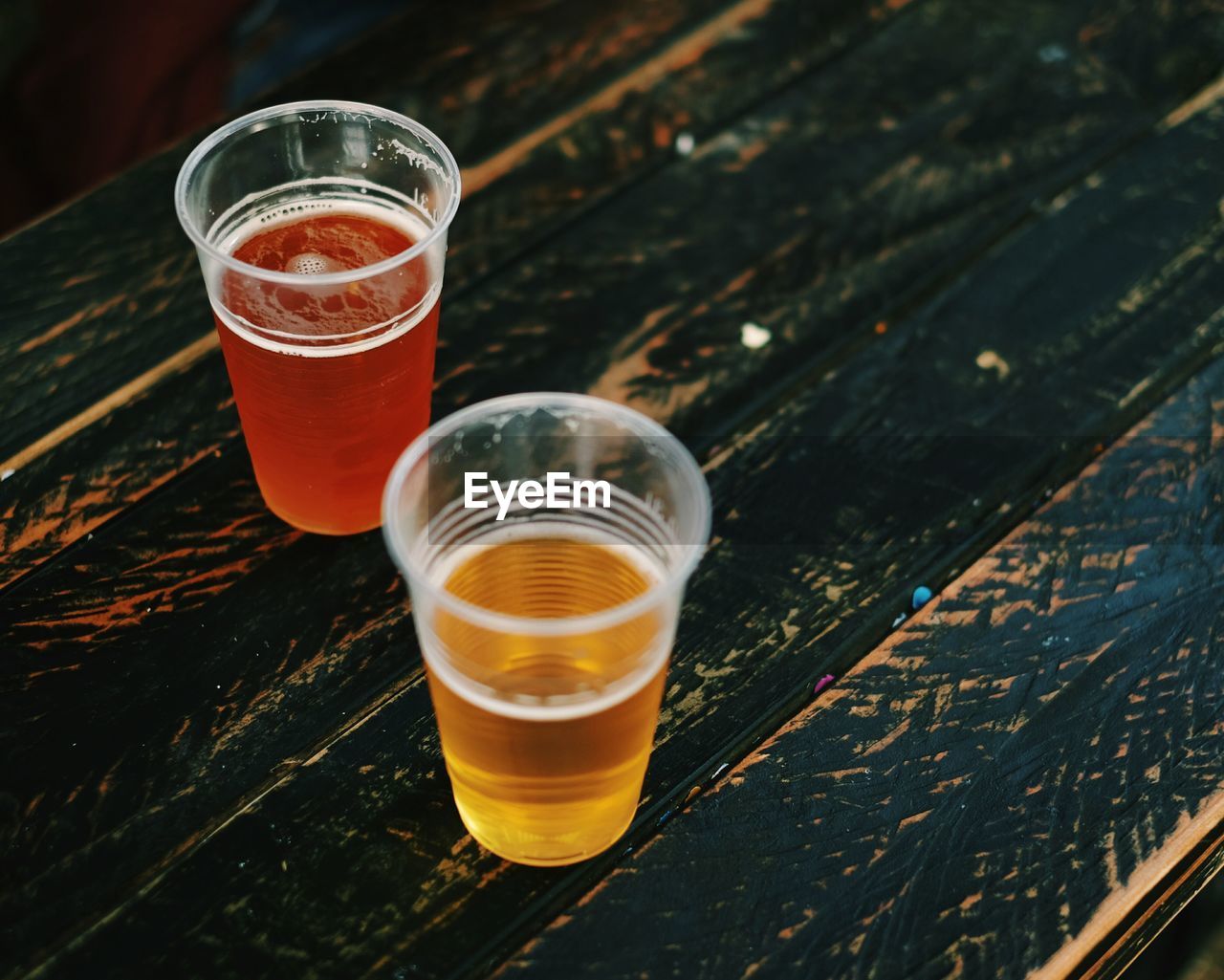 High angle view of beer in glasses on wooden table