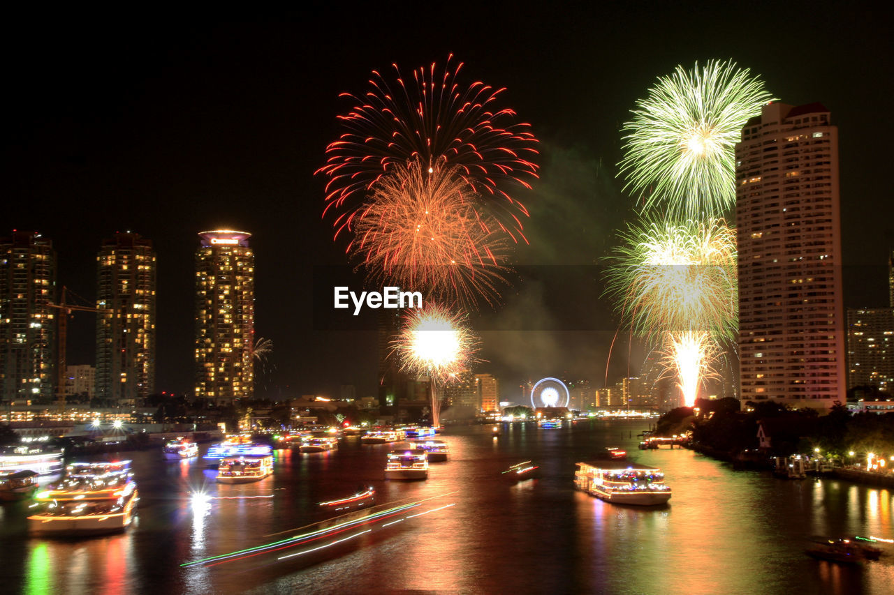 FIREWORK DISPLAY OVER CITY AT NIGHT