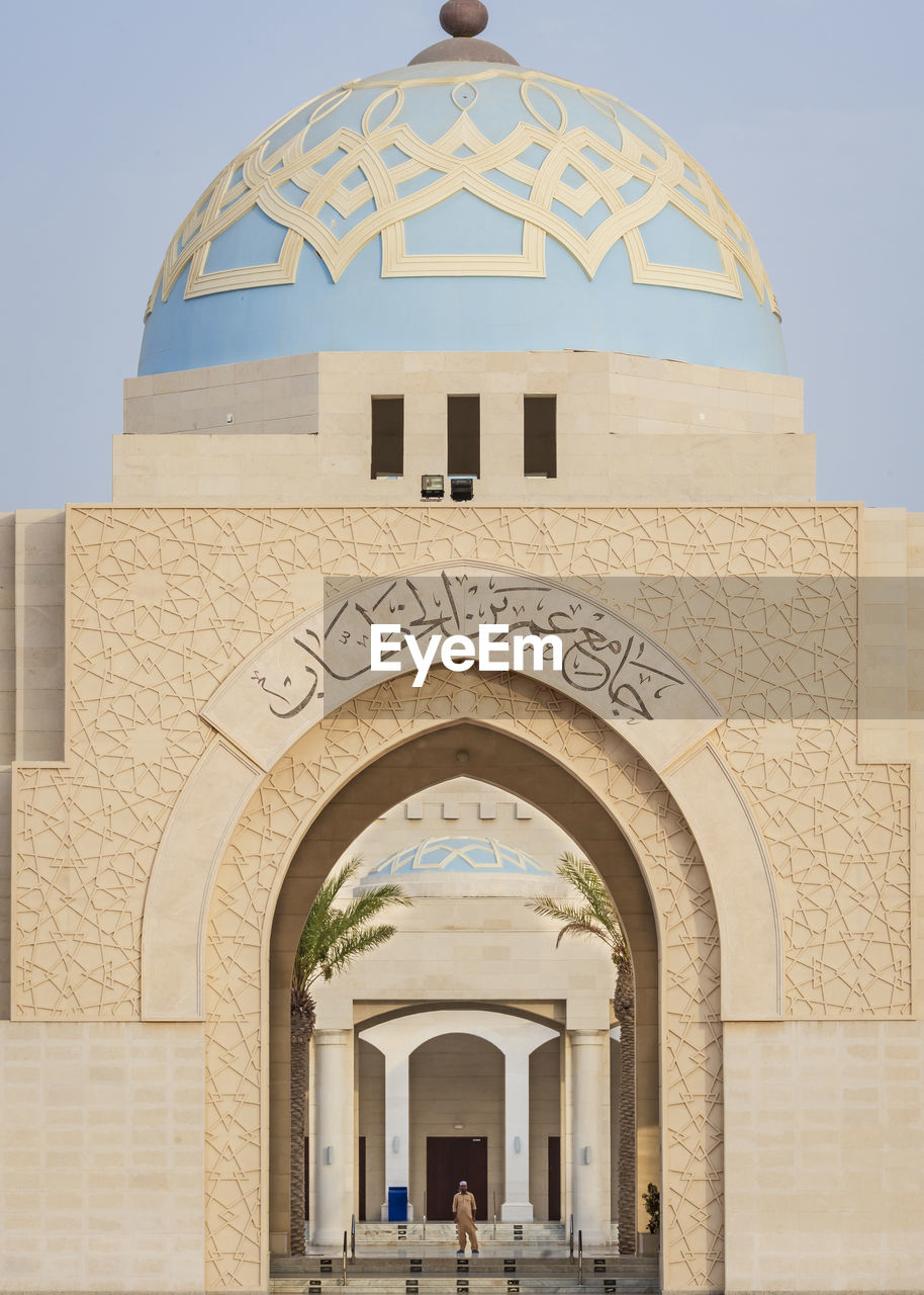 Mid distance view of mid adult man standing in mosque