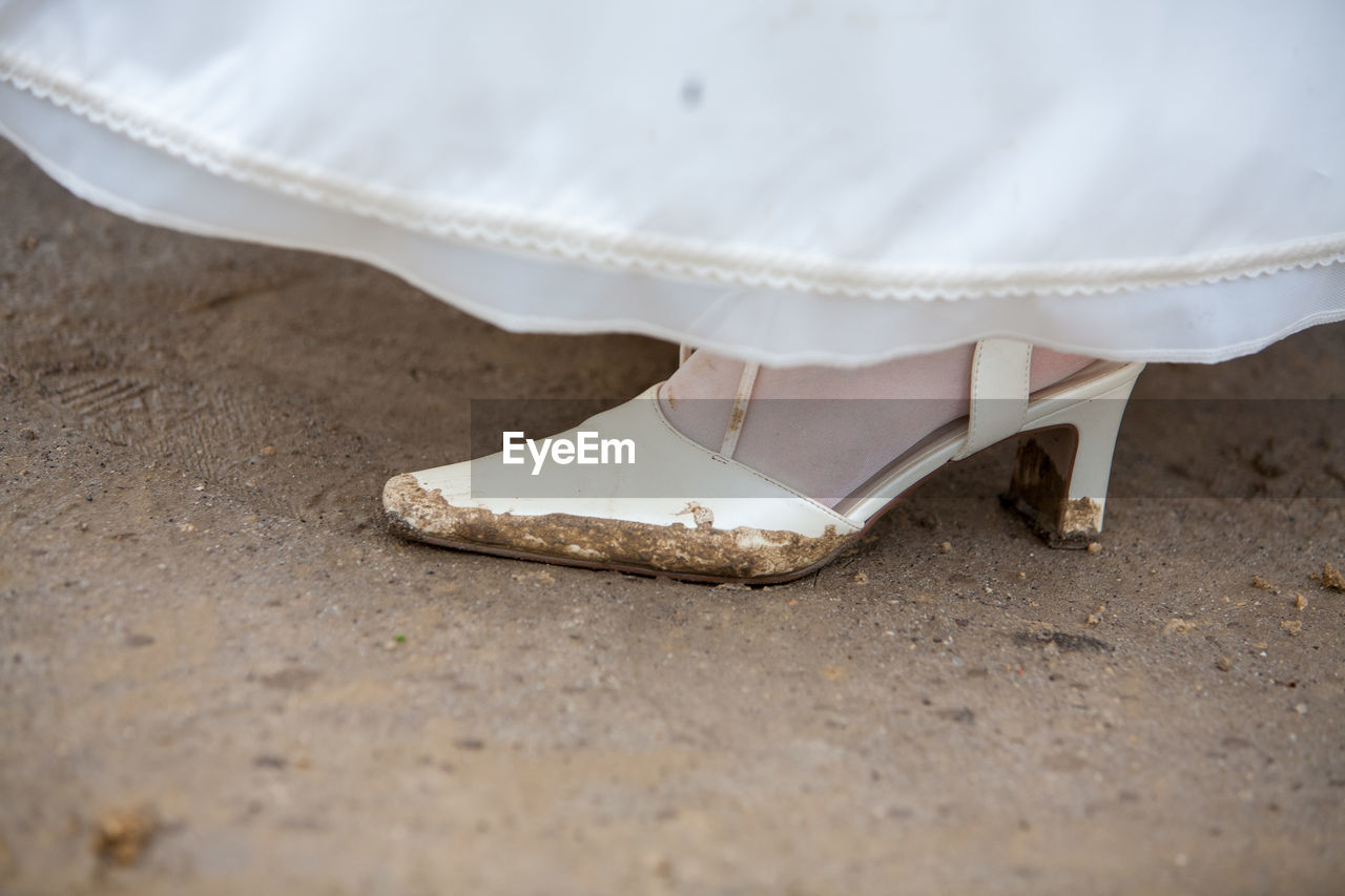 Low section of bride on dirt road