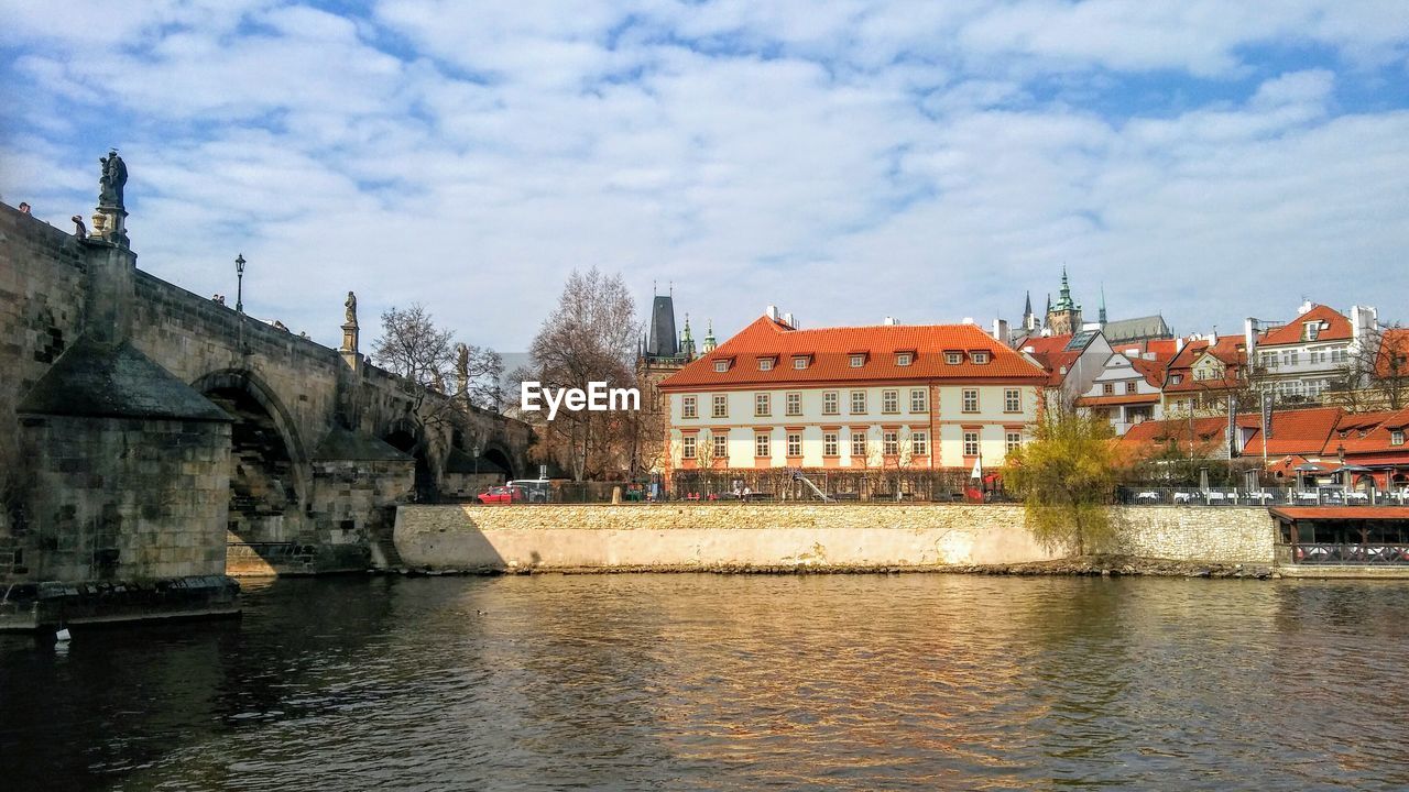 River by buildings against sky in city