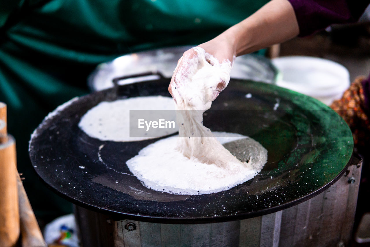 Cropped image of person preparing food