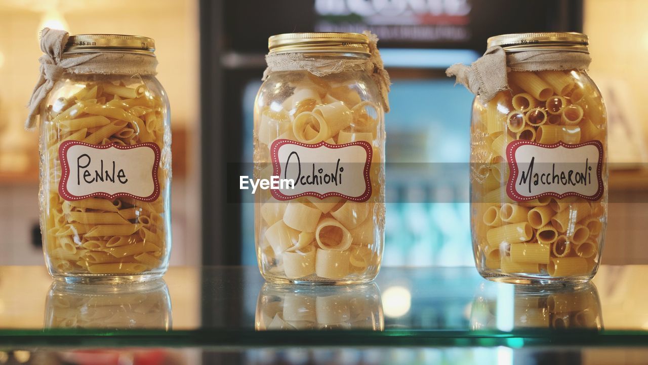 Close-up of pastas in jars at shop