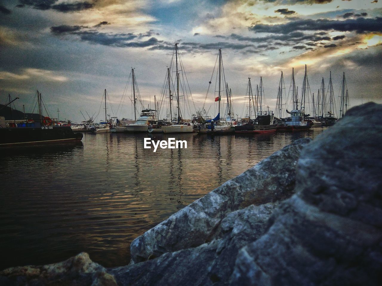 SAILBOATS MOORED IN SEA