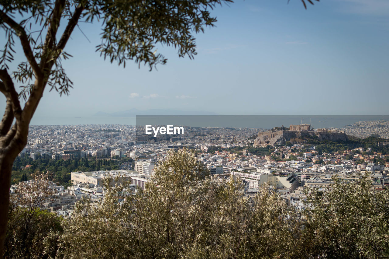 High angle shot of cityscape against sea