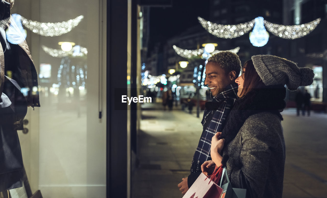 Young couple looking in shop window