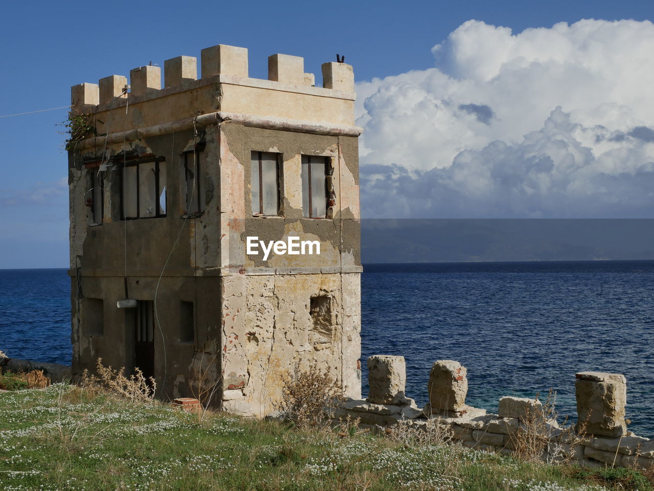 CASTLE BY SEA AGAINST SKY