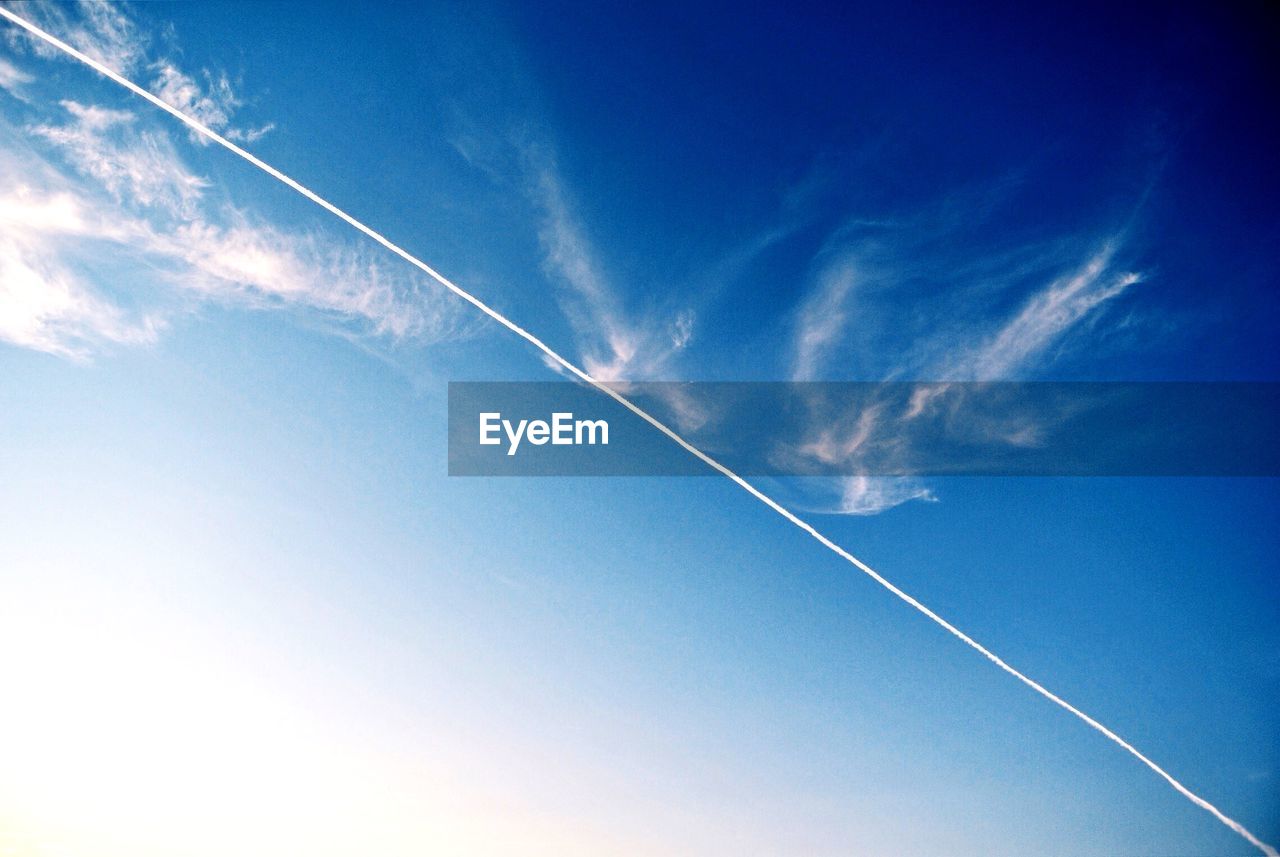 LOW ANGLE VIEW OF VAPOR TRAILS IN SKY