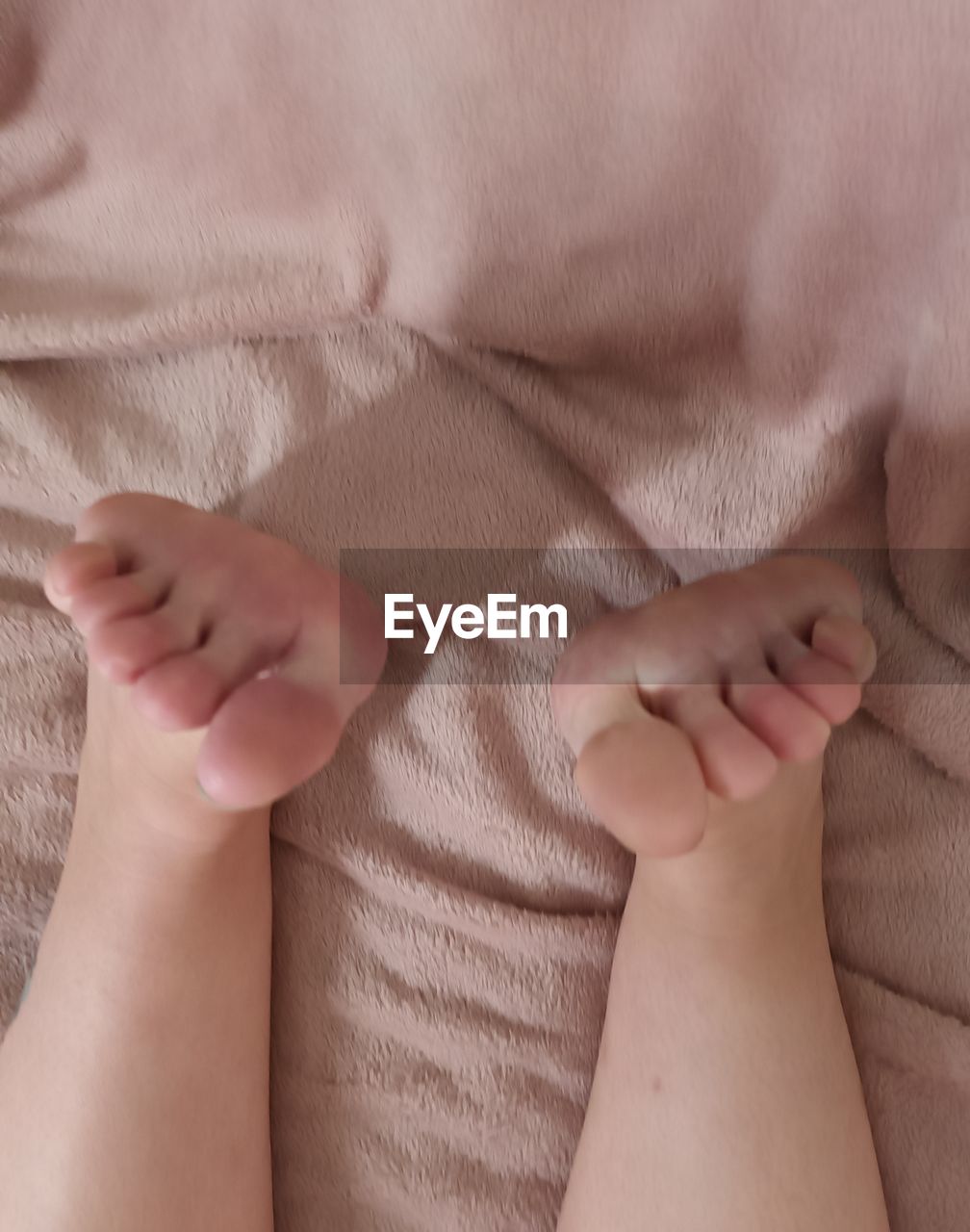 human leg, baby, hand, limb, indoors, toddler, close-up, child, women, adult, finger, furniture, skin, arm, human foot, one person, textile, childhood, barefoot, relaxation, bed, female, high angle view, babyhood, lying down, love, clothing, linen, emotion, person, human limb