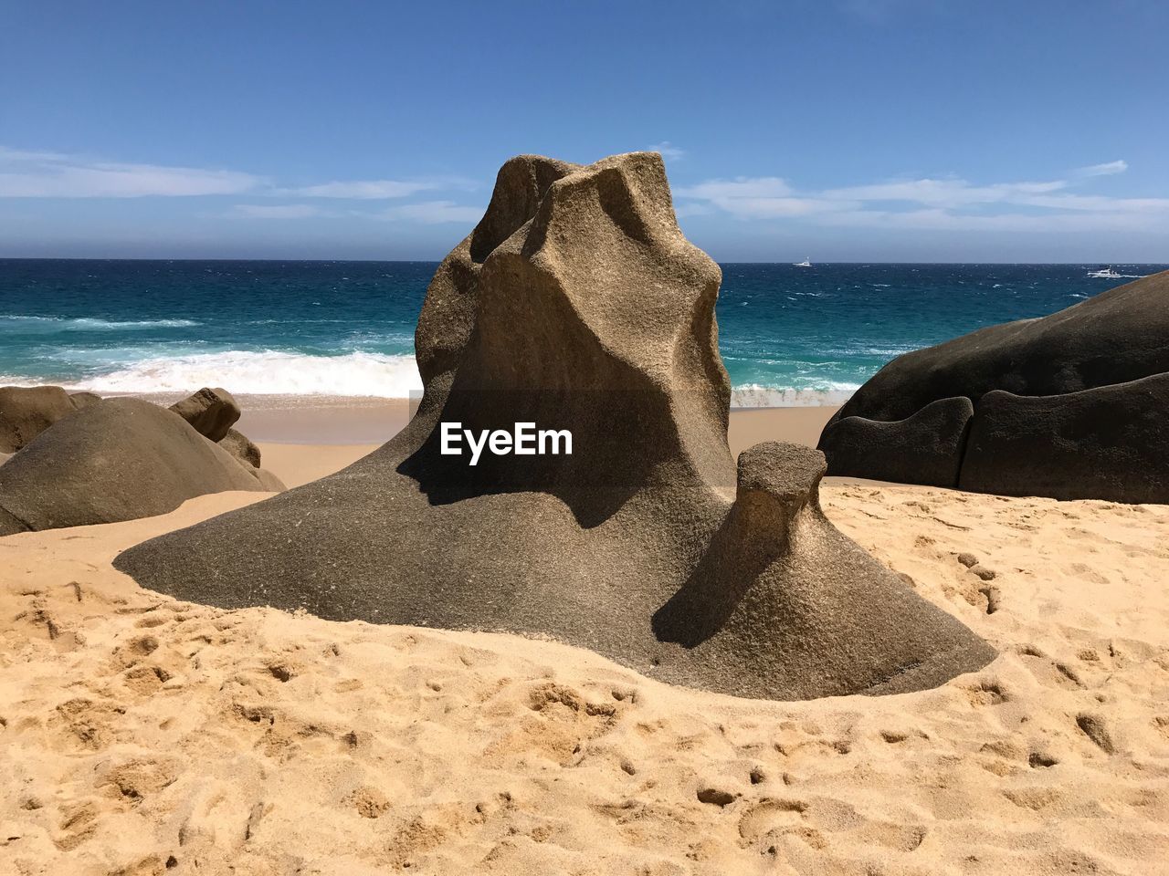 Scenic view of rocks on beach against sky