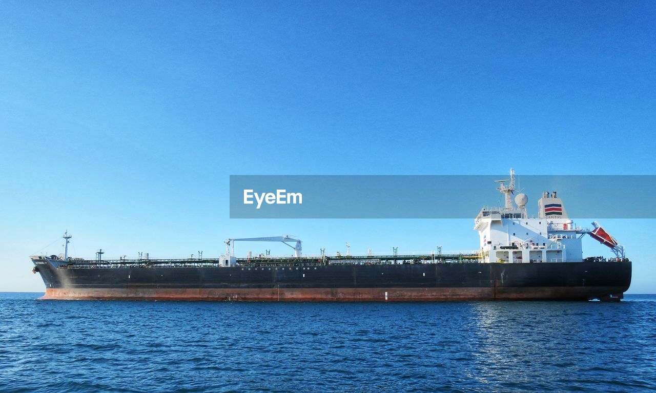 SHIP AT SEA AGAINST CLEAR BLUE SKY