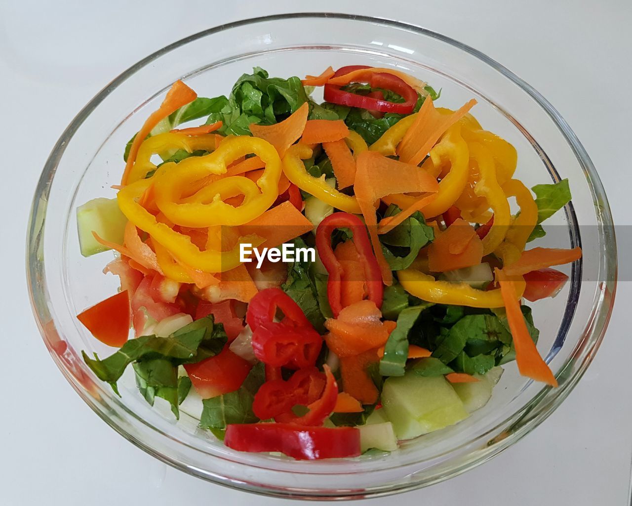 Close-up of chopped vegetables in bowl over white background