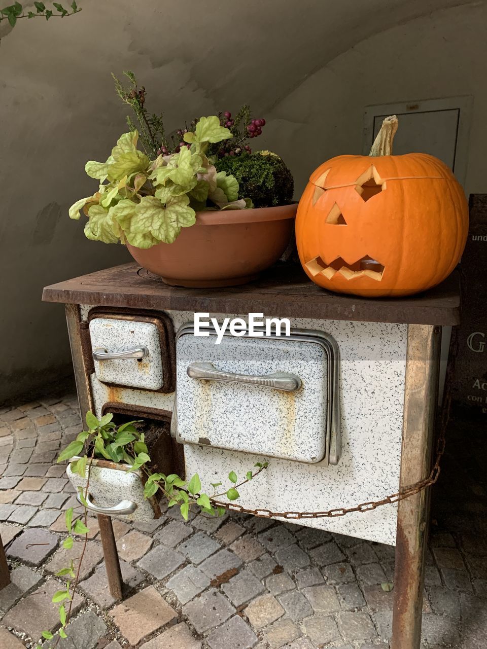 High angle view of old fashioned stove with pumpkin 