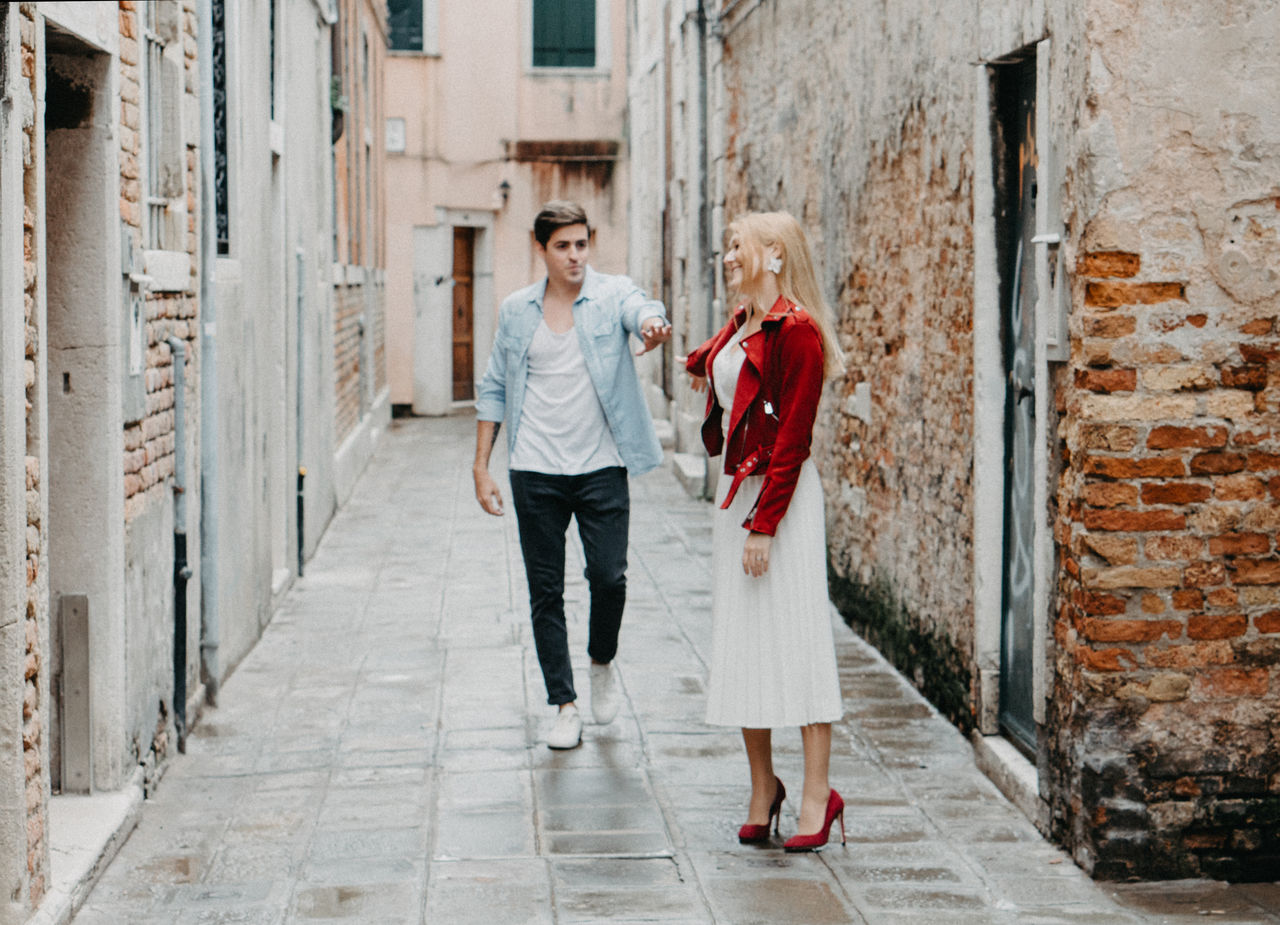 HAPPY FRIENDS STANDING ON COBBLESTONE