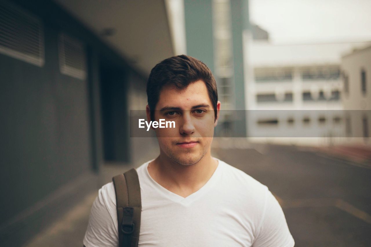 Portrait of young man in city