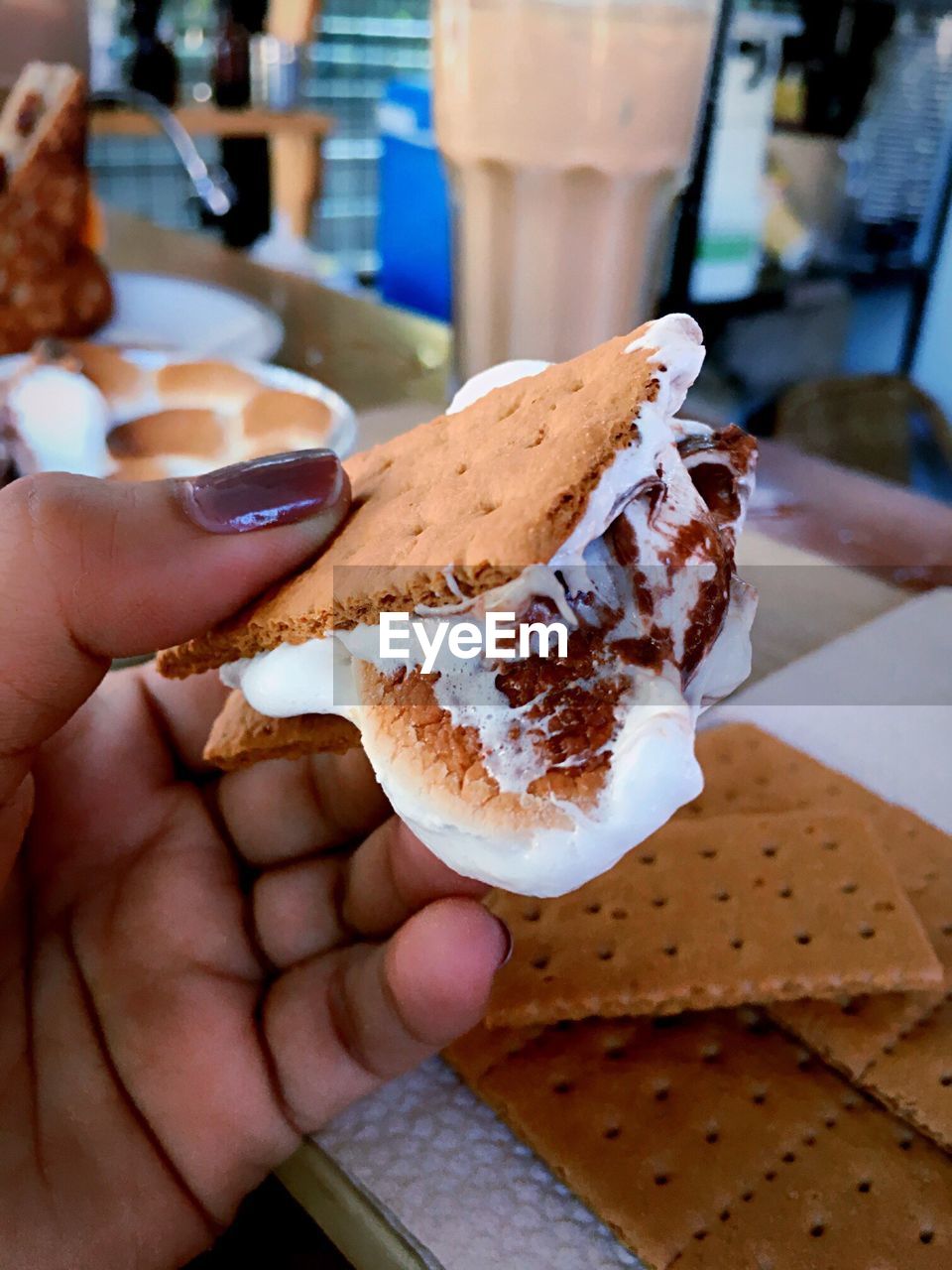 Cropped hand of woman holding smore