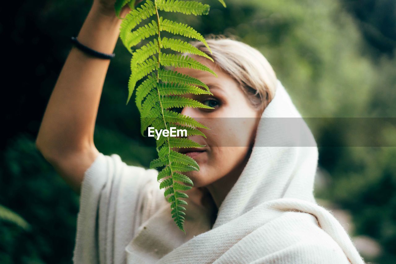 Midsection of woman holding plant