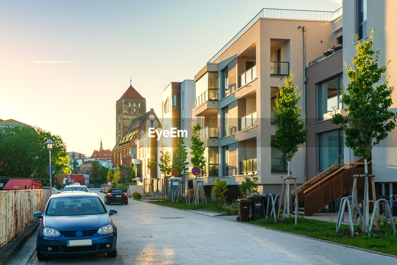 Cars on road amidst buildings against sky