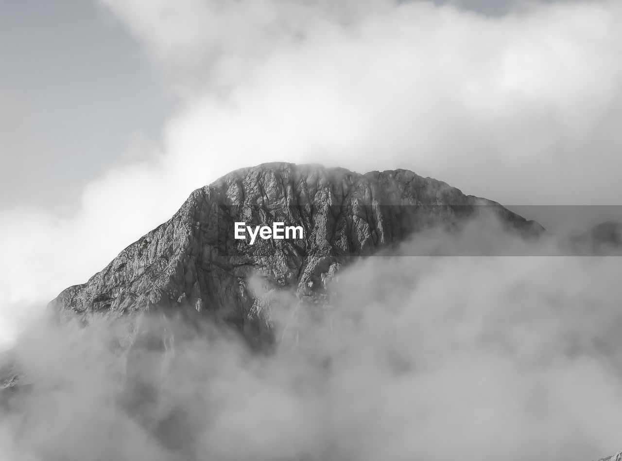 Cloudy rock formaion in the alps