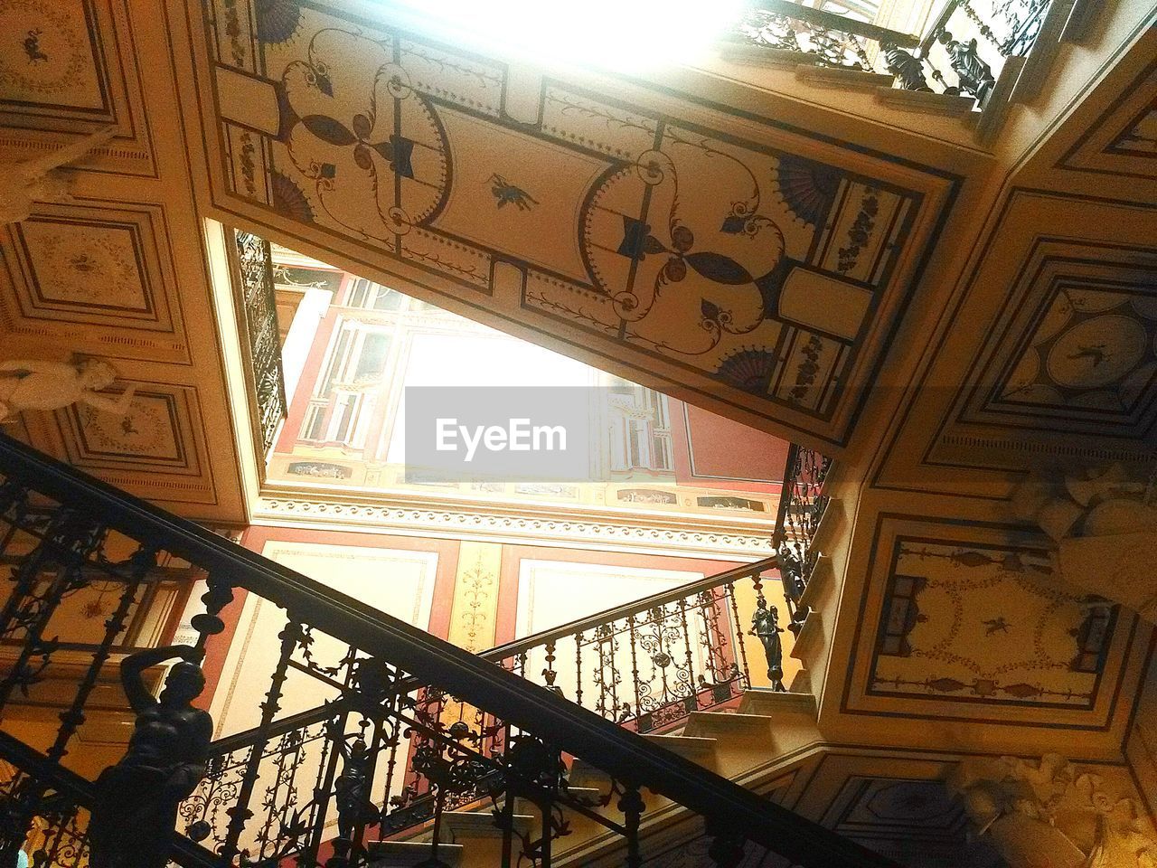 Ornate staircase with frescoes on ceiling