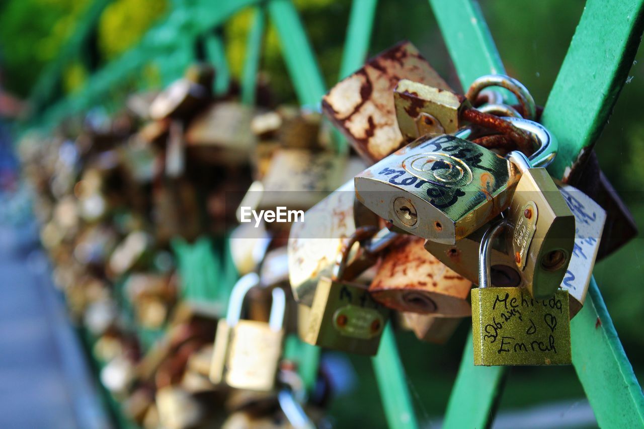 Close-up of padlocks on railing