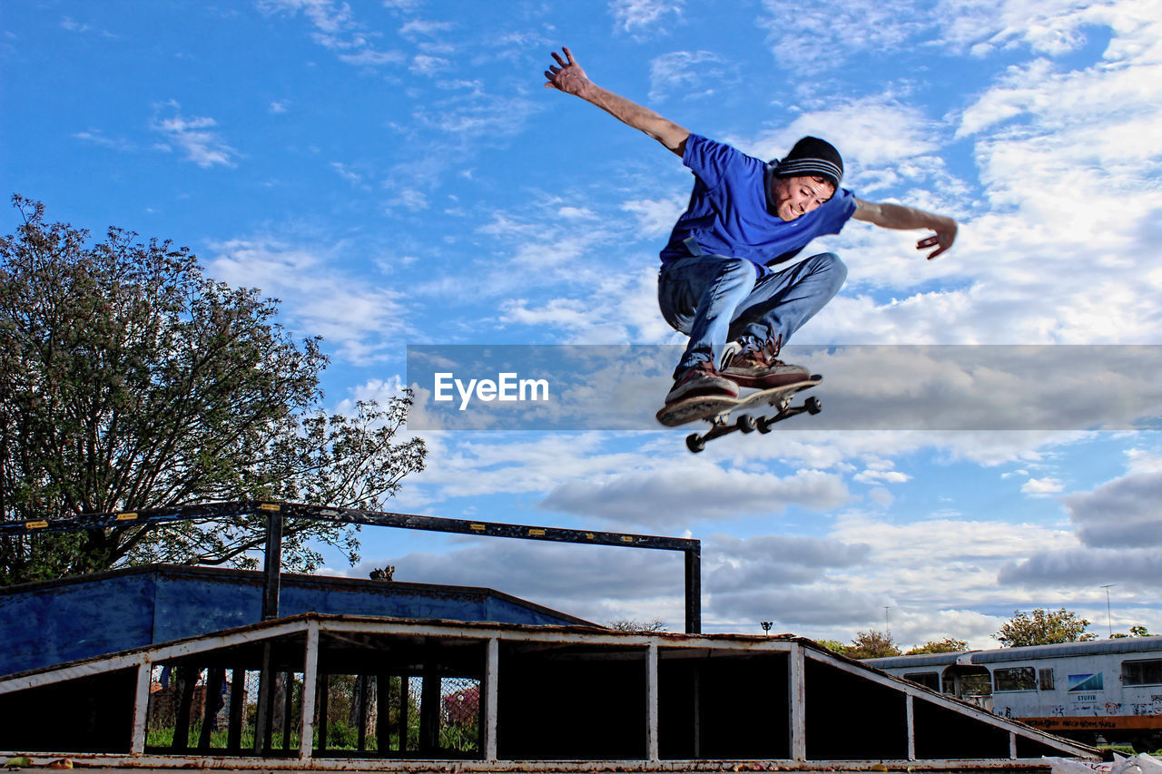 Skateboarder ollie in ramp