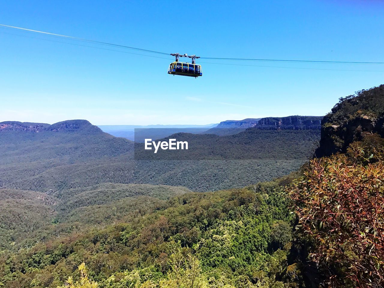 AIRPLANE ON MOUNTAIN AGAINST CLEAR SKY