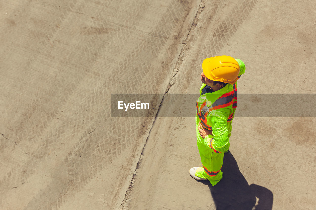 HIGH ANGLE VIEW OF PERSON WALKING ON BEACH