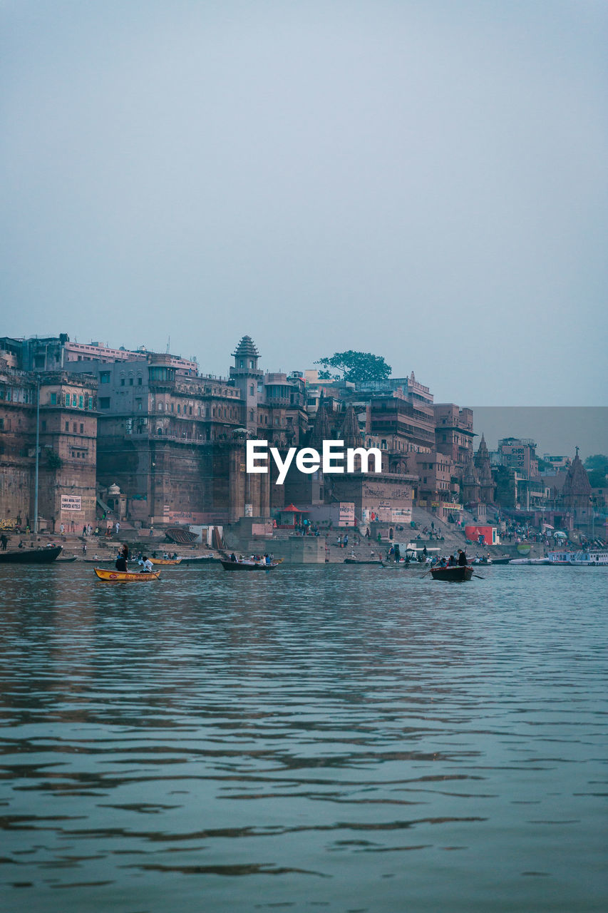 SCENIC VIEW OF SEA AGAINST BUILDINGS IN CITY