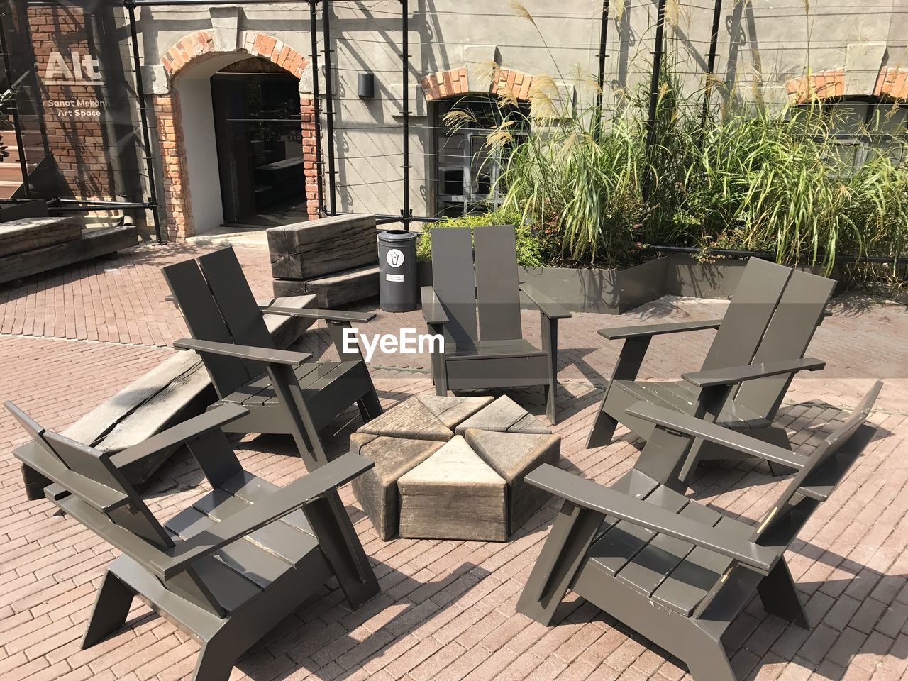 CHAIRS AND TABLE BY POTTED PLANT